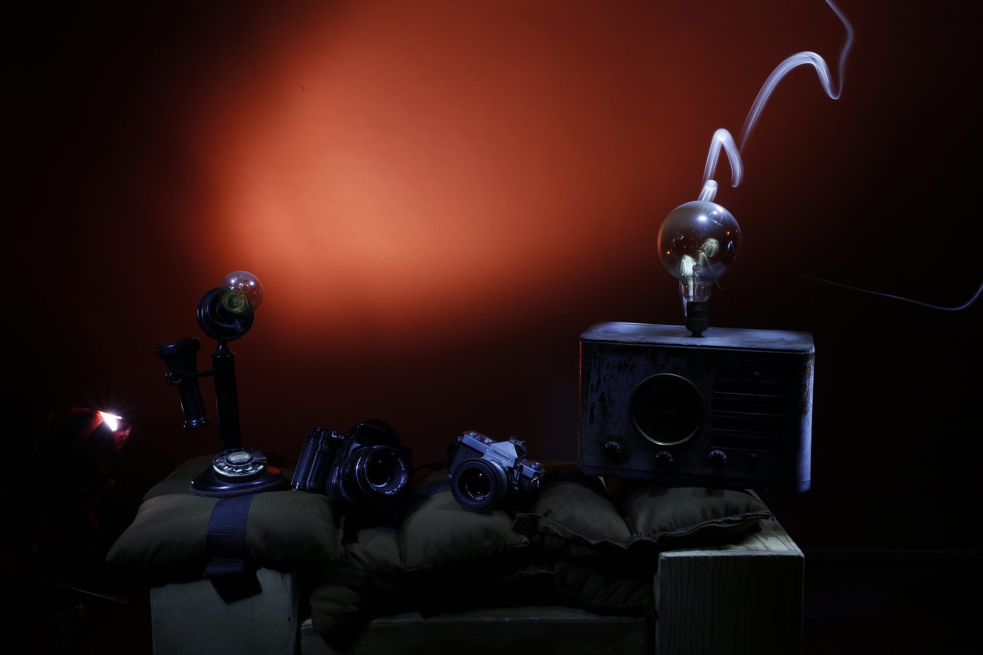 Vintage cameras and radio with warm light trail